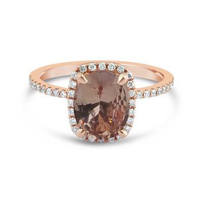 Rose gold halo ring with Topaz center and diamonds