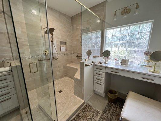 Frameless shower glass doors and panels with a custom bench seat