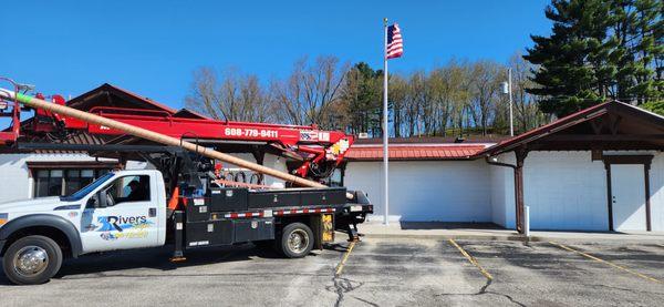 Installation of flagpole by 3 Rivers Sign