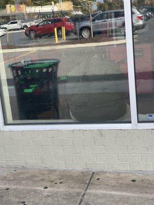 Cashier relaxing on windowsill