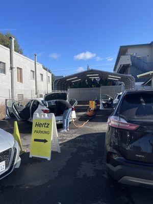 Manager cleaning rental while there's 10 people waiting for service