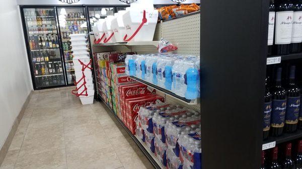 Packaged drinks are by the wall