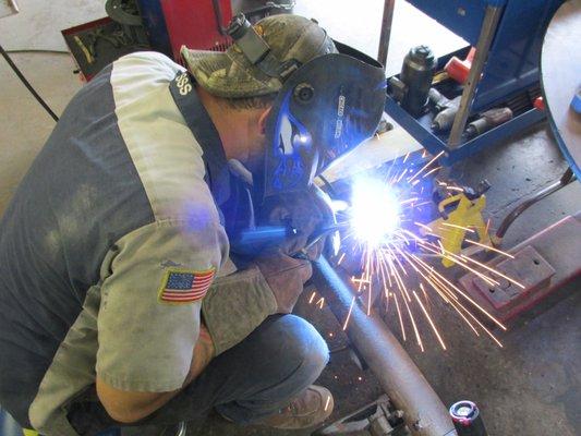 Shop manager, Trevor Demske repairing 69 GTO Judge rear shock perch