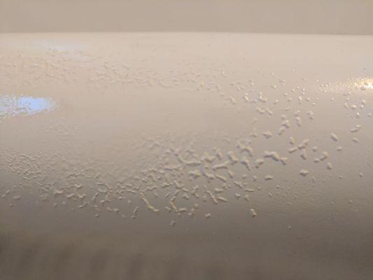 A picture of glaze bubbles that our bathtub is covered after the service.