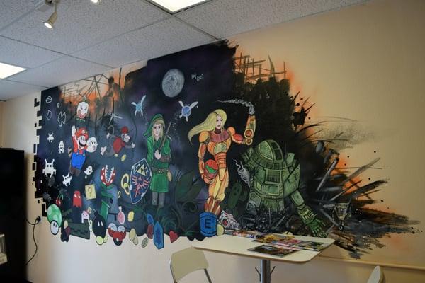 Mural depicting video games through the ages on the wall