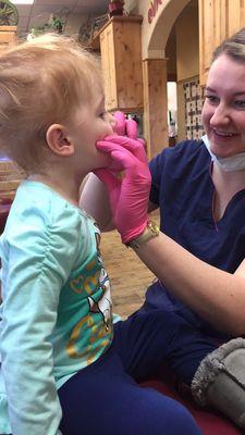 Kylie checking out our daughter's teeth!