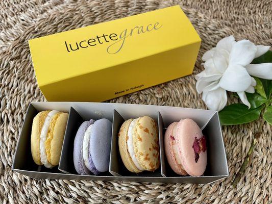 Box of four macarons: lemon with raspberry, lavender, coconut and rose