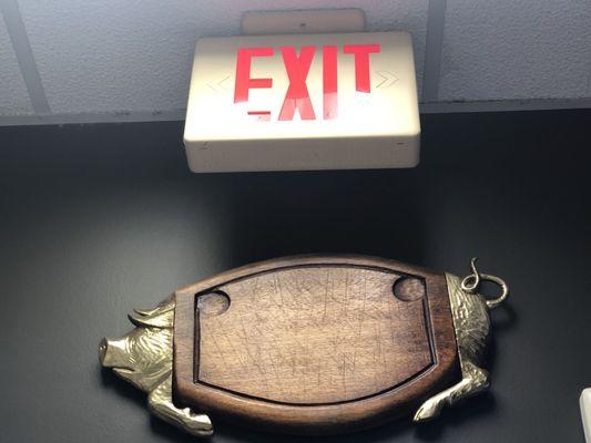 Wood pig/ hog sign below Exit sign