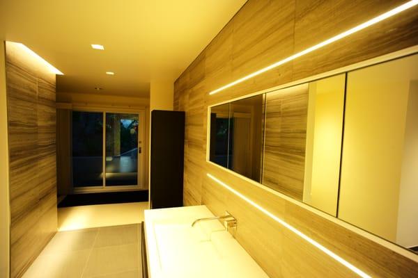 Recessed LED strip, Made in America, illuminating a bathroom.  Also, trimless, square LED recessed lights for general lighting.