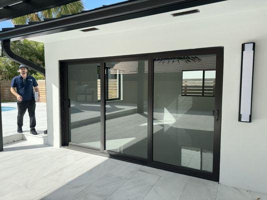 Three panel sliding glass door patio entrance from the outside