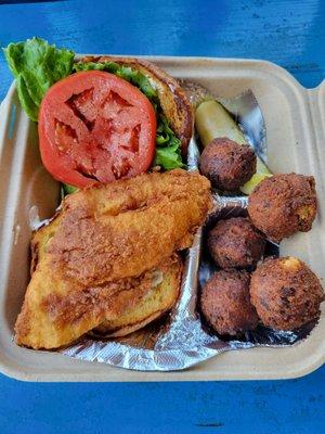 Fried grouper sandwich with hush puppies side