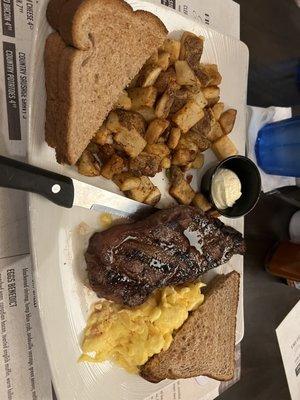 The New Yorker: 8oz strip, 2 eggs, potatoes or grits, toast or biscuit