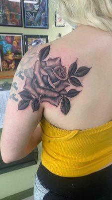 Black and grey rose tattooed by Anthony