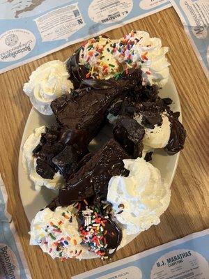 Double fudge chocolate cake with hot fudge, vanilla ice cream, whipped cream, sprinkles and Oreo cookie bites