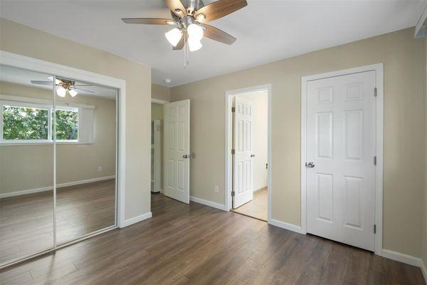 Large bedroom  closet mirrored doors and spacious linen closet