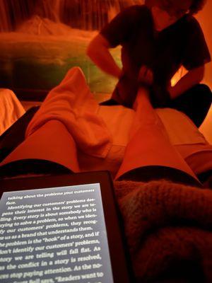 Reading while getting a massage