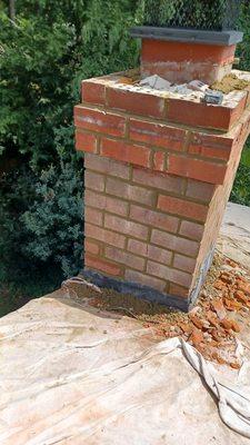 Replace some spoiled bricks repointed top of Chimney on all four sides and new concrete crown