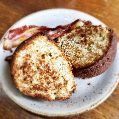 Two giant slices of banana bread with a side of bacon