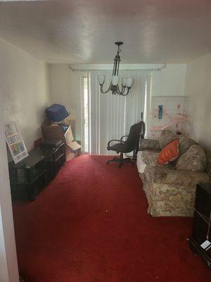 Dinning room left behind furniture and animal cage. Broken light fixtures.