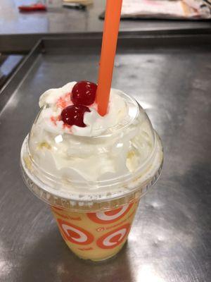 Swizzle of salted caramel with mango flavored Bobas, topped with Redi Whip and cherries