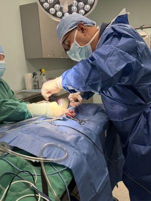 Dr. Shah and surgical assistant performing a splenectomy.