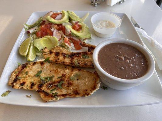 Grilled chicken with salad and beans.