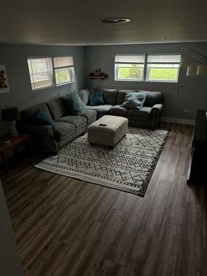 Finished basement with vinyl flooring.