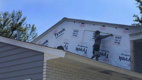 What goes underneath siding and roofing materials is important.  Here, our crew uses Tyvek house wrap to add protection under the new siding