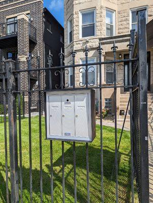 Mail boxes assembly welded and install on a building metal fence, Chicago Locksmiths install