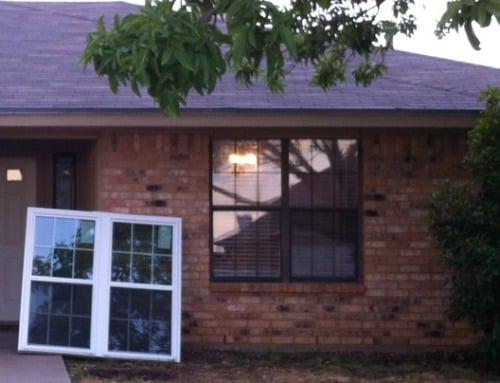 Installation in progress: the white window is the NEW double hung window from Window Depot.