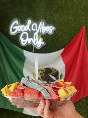 Pepinos Cubiertos (chamoy cucumbers) with watermelon, mango, sour strips, chamoy gummies and Japanese peanuts.