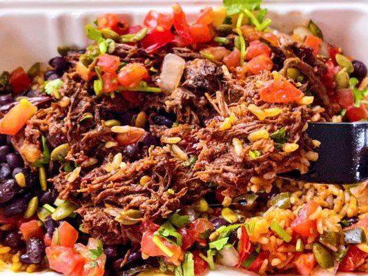 beef barbacoa bowl over rice after a few bites