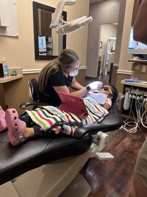 Kayla cleaning my daughter's teeth