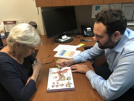 Our dispenser is educating our patient about how the ear processes sound.