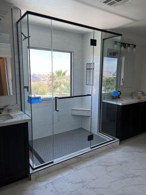 Frameless shower enclosure with header