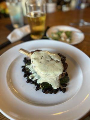 Pork chop on black beans & baby zucchini