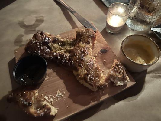 Rustic pretzel board with beer cheese, stone-ground mustard, and orange fig jam