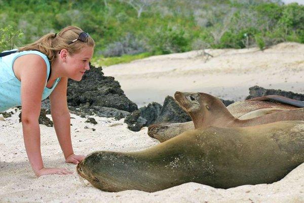 Largay Travel client getting up close and personal with a seal during her vacation