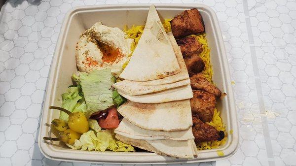 Chicken Kabob Plate with rice, hummus and salad.