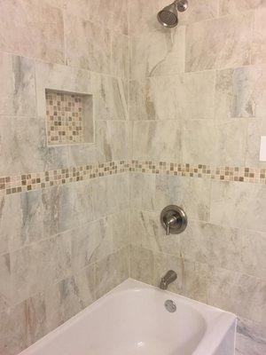 Earth tone tiles with niche and decorative tile strip