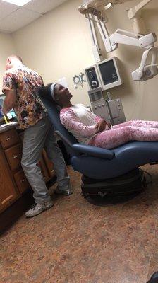 My daughter getting her teeth checked out with the amazing doctor Mr. Tim