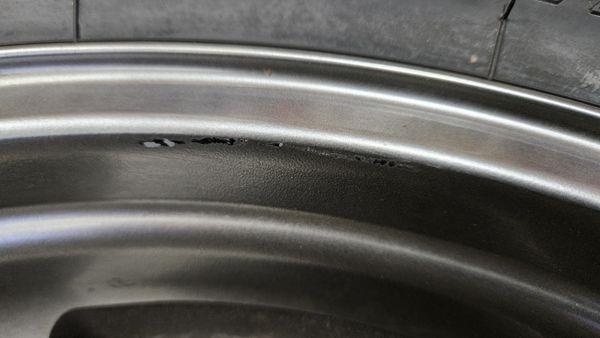 Major scratches created when RMS rotated wheel/tire on mounting machine.