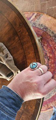 Large robin egg blue turquoise stone with heavy veining in silver setting.