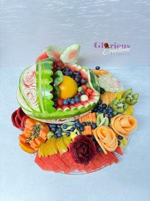 Fruit arrangement and carved baby carriage from watermelon