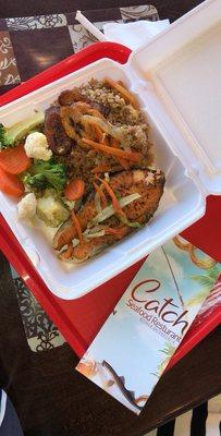 Grilled Salmon with rice and peas, fried plantain and steamed vegetables.