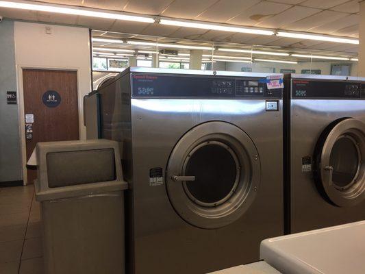 "Big Load" washer with an "Out of Order" sign and the locked bathroom to the left.