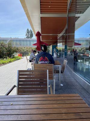 Several tables outside and a few chairs and booths inside