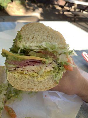 Turkey and pastrami with smoked cheddar and all the fixings on a sourdough roll. Add avocado and peppers