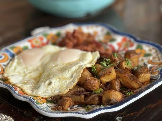 Over medium eggs, breakfast potatoes and perfectly crispy bacon