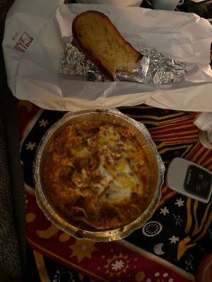 Lasagna and 7$ for burnt and tasteless garlic bread.